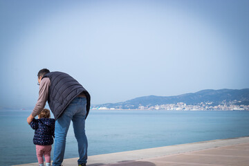 Seaside Balance: Father-Daughter Bonding Moment
