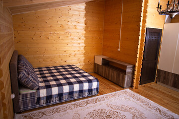 a small wooden holiday house with a bed