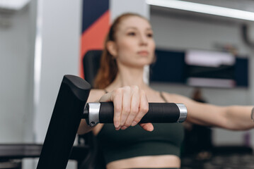 Fototapeta premium woman trains in fitness gym