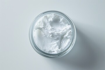 Open full jar of face cream, moisturizer. White glass cream jar on light gray background top view flat lay. Skincare and cosmetic, beauty product concept. Unlabeled bottle of balm or mask conditioner