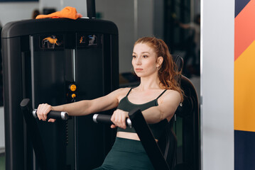 Fototapeta premium woman trains in fitness gym