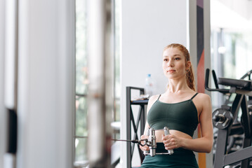 Fototapeta premium woman trains in fitness gym