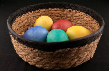 colorfully painted eggs in a wicker basket easter idea