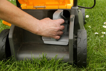 Close up image of lawn mower with inserted mulching plug, a cutting function that finely shreds the...