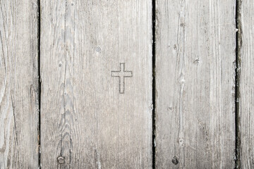 Grey wood texture background with carved cross, jesus, christian imagery