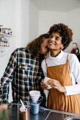 Affectionate couple enjoying morning coffee in kitchen