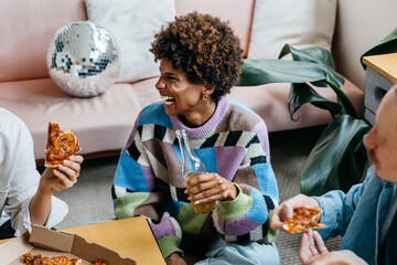 Colleagues sharing pizza in a cozy freelance workspace