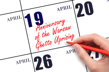 April 19. Hand writing text Anniversary of the Warsaw Ghetto Uprising on calendar date. Save the date.