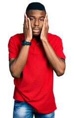 Young african american man wearing casual red t shirt tired hands covering face, depression and sadness, upset and irritated for problem
