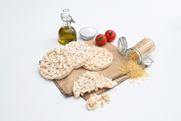 Gallette di riso o rice crackers on white background isolated whit tomatoes extra virgin oil and...