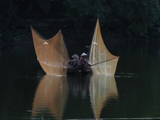 Pulling nets to catch fish on Nhu Y River, Hue. Photo taken in Hue in September 2022

