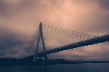 Low-angle of the Anzac bridge against cloudy and purple sky
