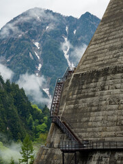 Metal steps leading vertically up the wall of a huge hydrolectric dam in Japan