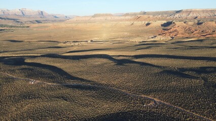 Fototapeta premium Aerial view of geological formations in Virgin town, Utah, in blue sky background
