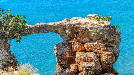 Big cliffs and rocks in Cabo Rojo Puerto Rico with the Caribbean Sea in the sunny background
