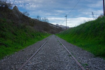Fototapeta na wymiar Abandoned tram rails in a countryside area