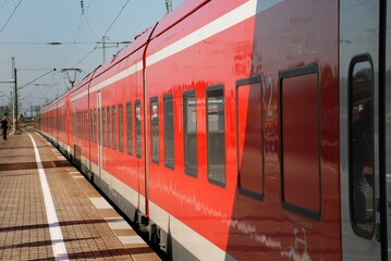 Closeup shot of a red train riding in the station