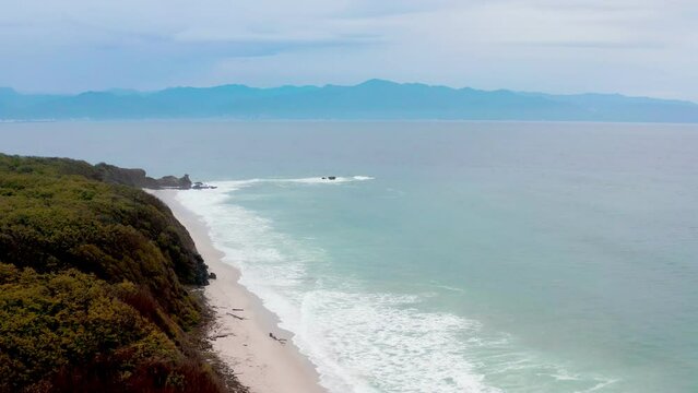 Aerial drone footage of Punta Mita beach in Jalisco, Mexico with blue ocean waves