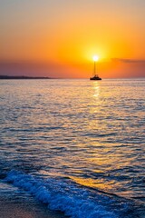 Silhouette of a sailboat on the sea during the sunset in Barcelona
