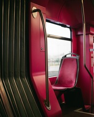 Vertical shot of a red empty seat on a bus