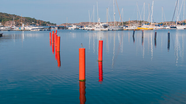 Scenic view of boats moored at the harbor reflecting a blue sea in Fjallbacka, Sweden