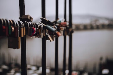 Closeup shot of love locks on the bridge on a blurred background - Powered by Adobe