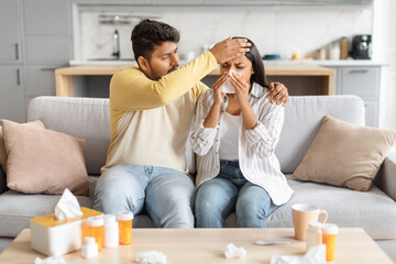 Caring Indian Man Comforting Ill Woman in Home Living Room