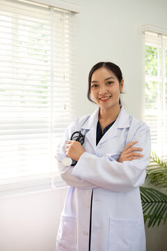Confident female doctor Smiling woman standing holding stethoscope in clinic