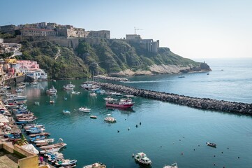 Drone view of the pretty island of Procida with boats and colorful houses, Naples, Italy