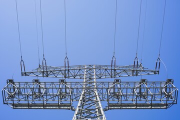 Low angle view of the transmission tower against a clear blue sky - Powered by Adobe