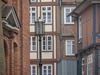 Street lamp and old European brick buildings in Stade, Germany.