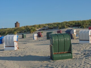 View of different booths on a white sand beach.