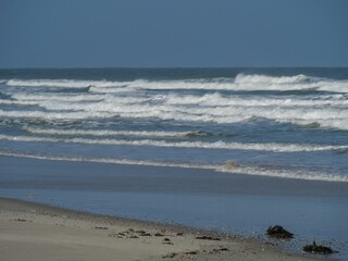 View of waves from the white sand beach.