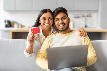 Indian Man and Woman Sitting on Couch Holding Red Card