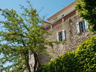 Low angle exterior of a medieval stone traditional houses with blue sky in Le Castellet, France