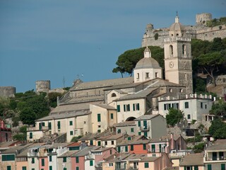 Fototapeta na wymiar Image of several buildings on a mountain surrounded with trees in Porto Venere, Italy