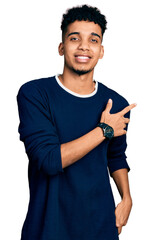 Young african american man wearing casual clothes cheerful with a smile on face pointing with hand and finger up to the side with happy and natural expression