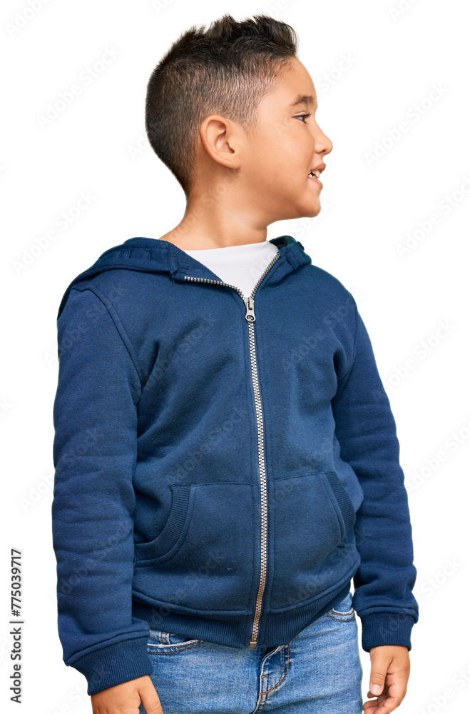 Sticker Little boy hispanic kid wearing casual sporty jacket looking away to side with smile on face, natural expression. laughing confident.