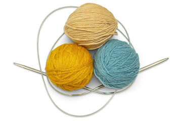 Several multi-colored skeins of wool yarn with knitting needles, isolated on a transparent background. Hobby, handicraft concept.