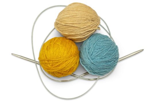 Several multi-colored skeins of wool yarn with knitting needles, isolated on a transparent background. Hobby, handicraft concept.