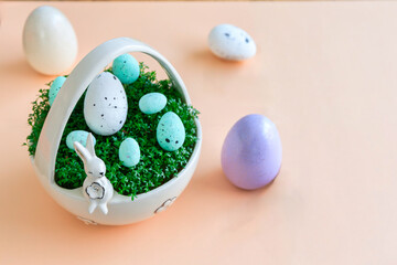 Porcelain basket with cress and Easter eggs on a pastel background