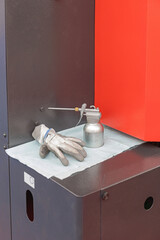 Pistol Oiler Can With Glove at Machine in Workshop