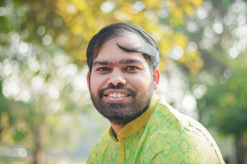 Portrait of Cheerful Happy handsome indian man looking in front of the camera. Indian man in...
