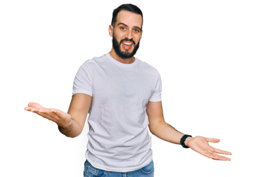 Young man with beard wearing casual white t shirt smiling cheerful with open arms as friendly welcome, positive and confident greetings