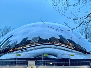 view of the famous Chicago Bean structure on a winter evening with the reflection of the city's...