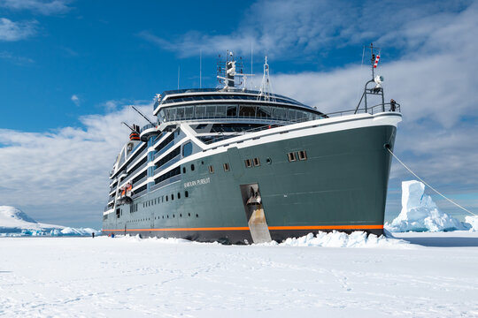 Hanusse Bay, Antarctica - January 14, 2024: Cruise ship Seabourn Pursuit breaking through sea ice in Antarctica.