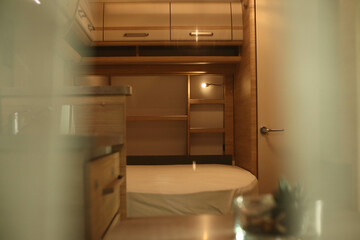Interior design of a bed room in a camper. Caravan, motorhome. Mobile home. Furniture
