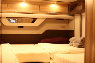 Interior design of a bed room in a camper. Caravan, motorhome. Mobile home. Furniture