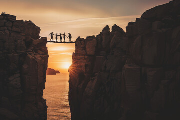 Silhouette adventure travelers group help crossing danger bridge in sea cliffs, overcome fear vertigo teamwork