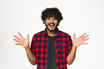 Extremely happy young Indian man expressing satisfaction isolated over white background. Cheerful...